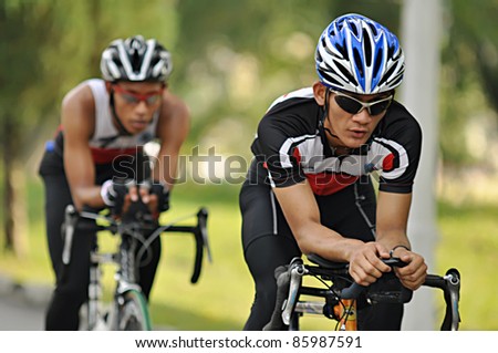 KUALA LUMPUR, MALAYSIA- SEPT. 24: An unidentified participant cycles after run 5km at Malakoff University Duathlon Series 2011, on September 24, 2011 in Kuala Lumpur, Malaysia