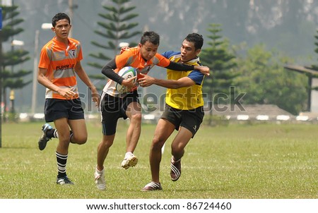 MALAYSIA - OCTOBER 15: Unidentified participants in action during a 10 Side Rugby Tournament Vice-Chancellor Cup at National Defense University Of Malaysia, Kuala Lumpur, Malaysia on October 15, 2011.