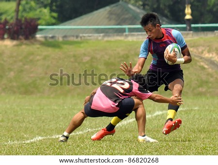 MALAYSIA - OCTOBER 15: Unidentified participants in action during a 10s Rugby Tournament Vice-Chancellor Cup at National Defense University Of Malaysia, Kuala Lumpur, Malaysia on October 15, 2011.