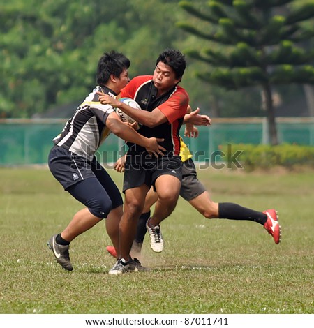 KUALA LUMPUR, MALAYSIA - OCTOBER 15: Unidentified participants in action during a 10s Rugby Vice-Chancellor Cup at National Defense University Of Malaysia, Kuala Lumpur, Malaysia on October 15, 2011.