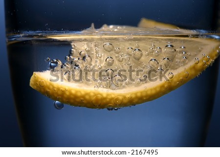 Lemon in glass with mineral water