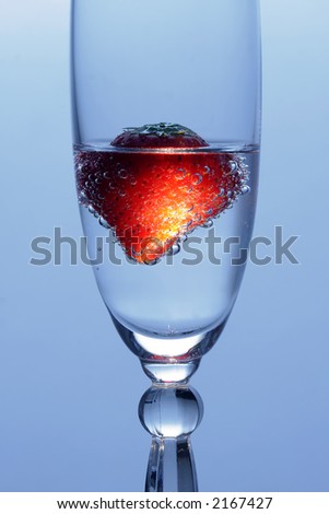 Strawberry in glass with mineral water