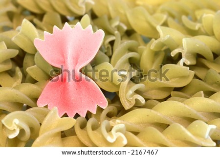 Bunch of raw pasta with one colored pasta