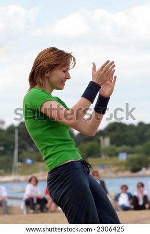 Young woman with her hands in air