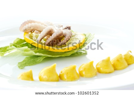 boiled octopus with a slice of lemon on a white background