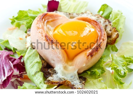 scrambled eggs with sausage on a heart-shaped leaves of lettuce