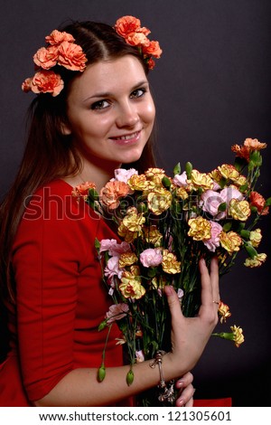 portrait of a girl with a bouquet of flowers on a black background