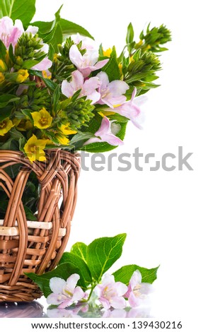 beautiful summer bouquet in a wicker basket on a white background