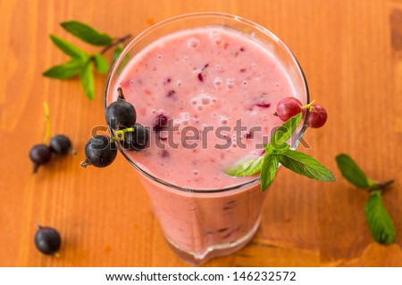 summer smoothies black currant in the cup on the wooden table