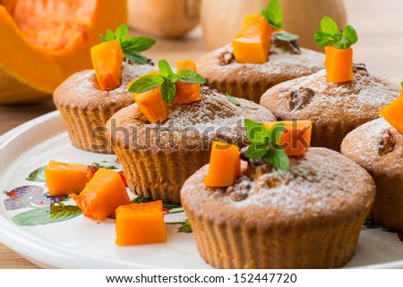 sweet pumpkin muffins with walnuts and powdered sugar