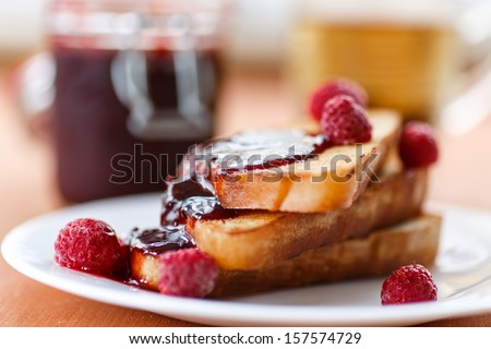 French toast with raspberry jam on a plate