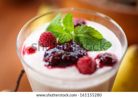 pear smoothie with berries and mint in a glass