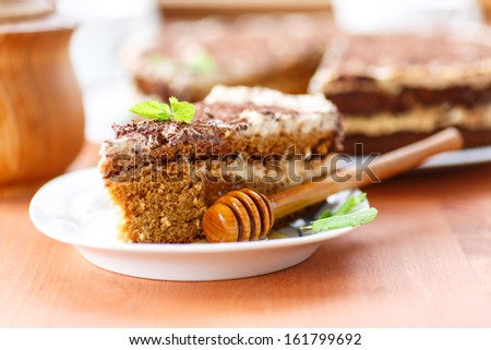 honey cake with sour cream on a plate