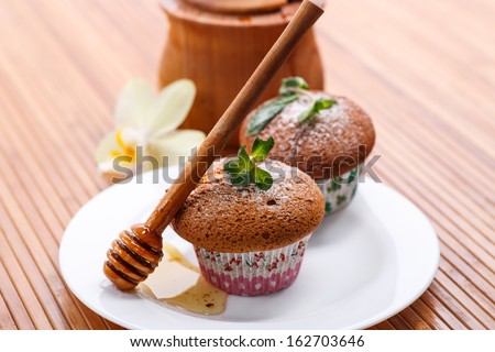 honey muffins with powdered sugar and mint