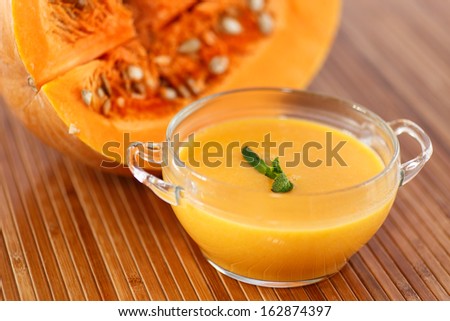 Sweet pumpkin soup in a bowl on the table