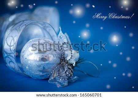 Christmas card with silver balls and ribbon on a blue background