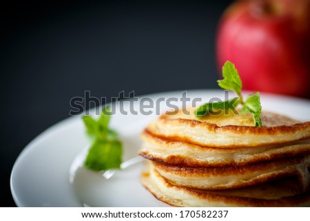 fried fritters with apples on a black background