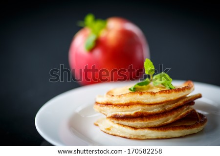 fried fritters with apples on a black background