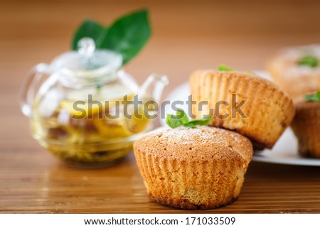 sweet apple muffins with tea on wooden table