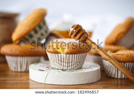 sweet honey muffins sprinkled with powdered sugar on a wooden table