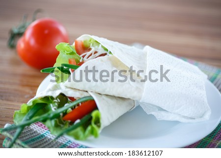 pita bread with lettuce and vegetables on a plate