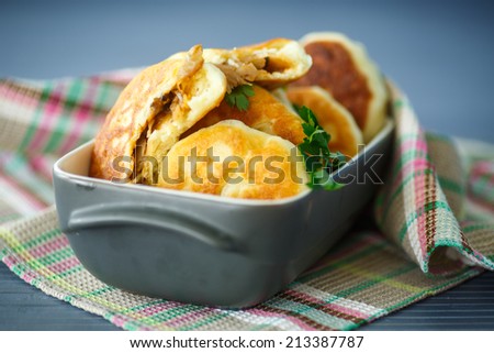 pies fried with cabbage on a wooden table