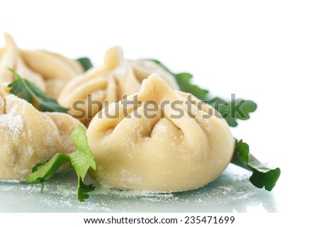 traditional raw manti with meat inside on a white background