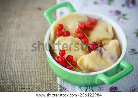 sweet dumplings with cheese and berries on a plate