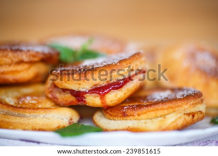fried cakes with jam decorated with mint