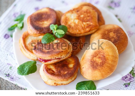 fried cakes with jam decorated with mint
