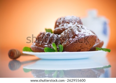 sweet honey muffins in powdered sugar on orange background