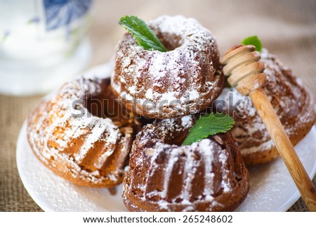 sweet honey muffins in powdered sugar on the table