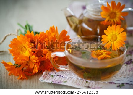 Herbal tea with marigold flowers on the table