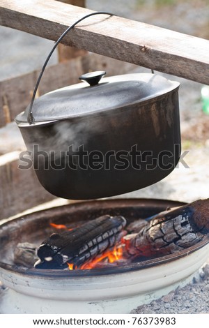 Lunch is cooked in a pot on the fire