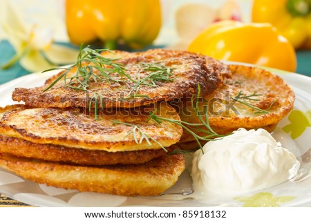 potato pancakes with dill and sour cream closeup