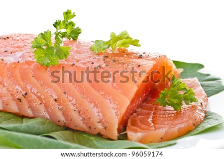 salted red fish with greens on a white background