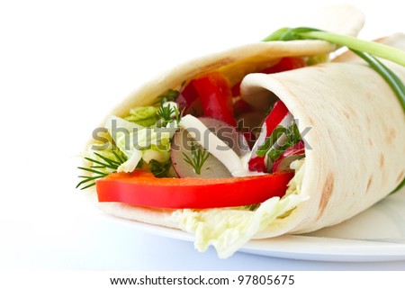 pita bread stuffed with vegetables on white background