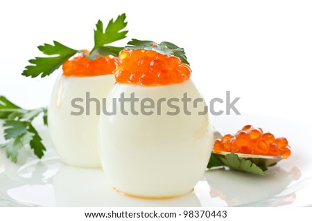 egg with red caviar on white background