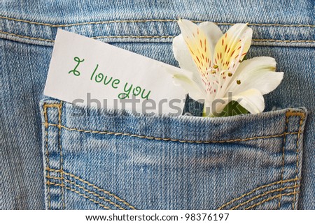 flower and a declaration of love in the back pocket of jeans