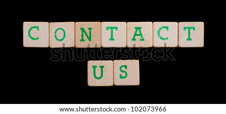 Green letters on old wooden blocks (contact us)