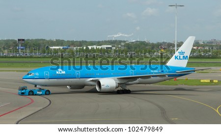 AMSTERDAM - MAY 11: KLM Boeing 737 is pulled by a special tow car at Schiphol airport on May 11, 2012, Amsterdam, The Netherlands. KLM is the flag carrier airline of The Netherlands.