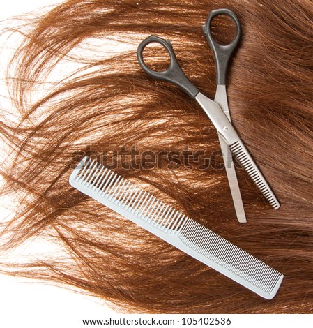 Brown hair and hairdresser\'s tools, isolated on white