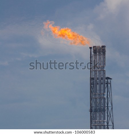 Burning oil gas flare during sunset (Rotterdam, Holland)