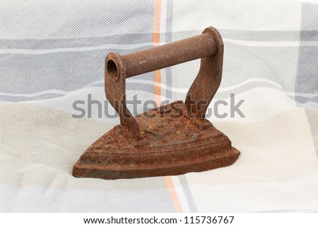 Old iron isolated on an old fabric
