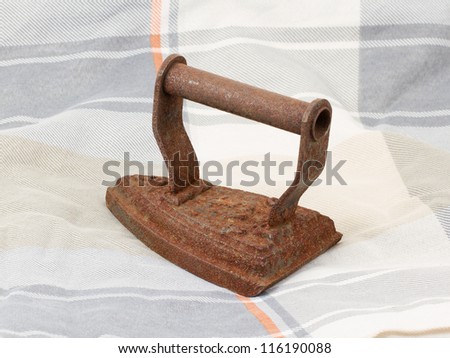 Old iron isolated on an old fabric