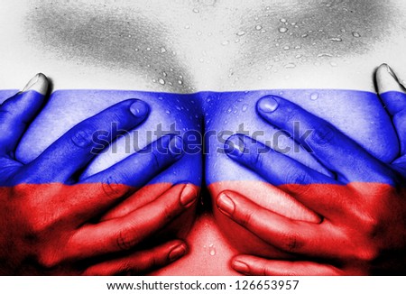 Sweaty upper part of female body, hands covering breasts, flag of Russia