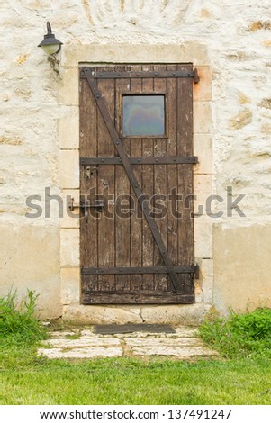 Old wooden door in an old stone wall