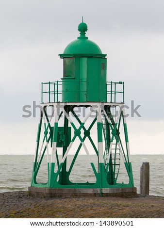 Green light beacon in a dutch harbor