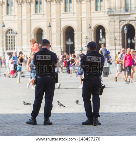 PARIS, FRANCE - July 28 : French police control the street at the Louvre during one of the busiest days of the year, Paris the 28 of July 2013, France