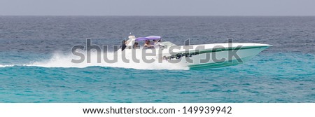 ST MARTIN - ANTILLES, JULY 19, 2013 - Speedboat with tourist on the Caribbean sea on July 19, 2013. Nearly 500.000 tourists visit St Martin every year, much for a isle with 75.000 inhabitants.